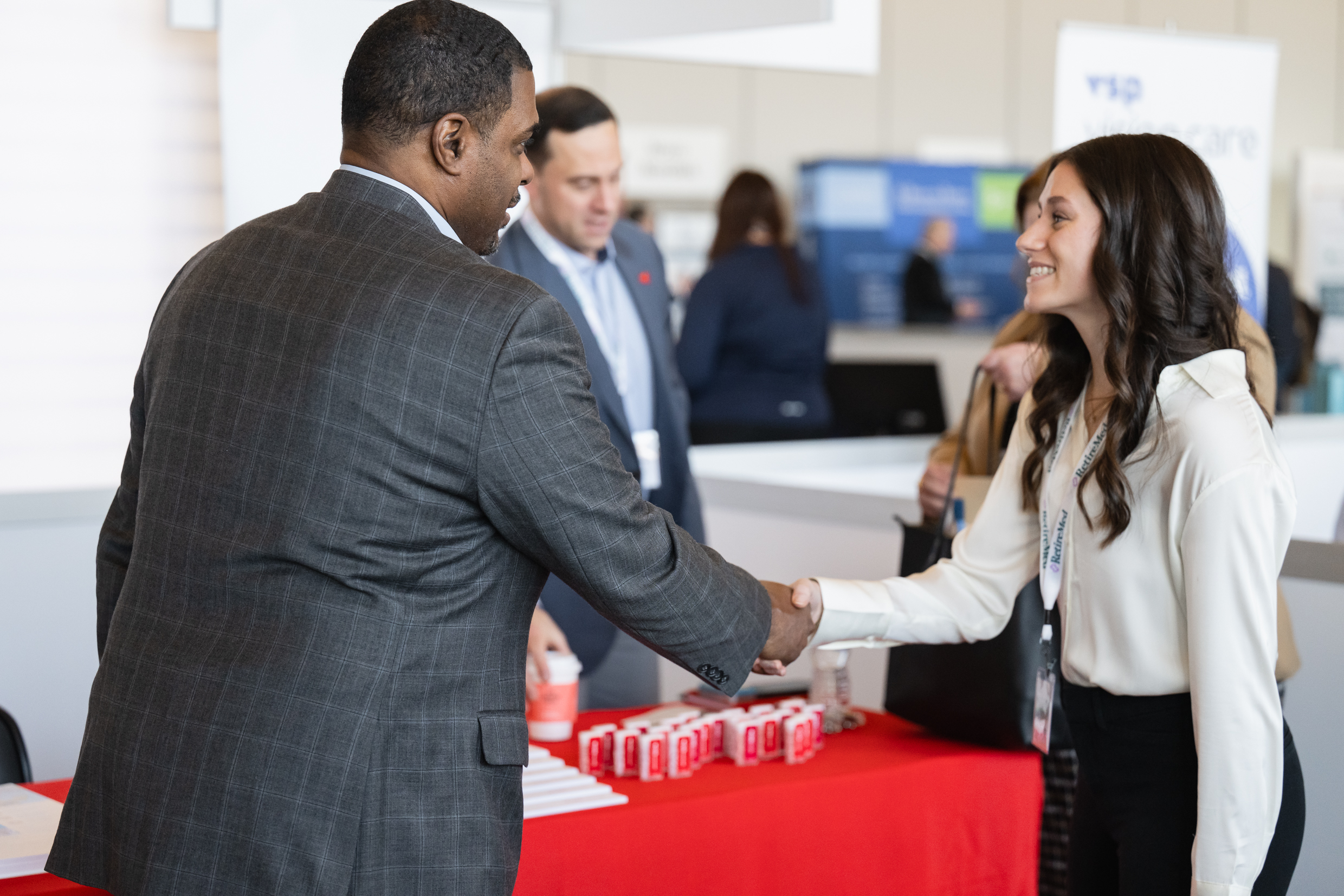 Young woman shaking hands with a business man.